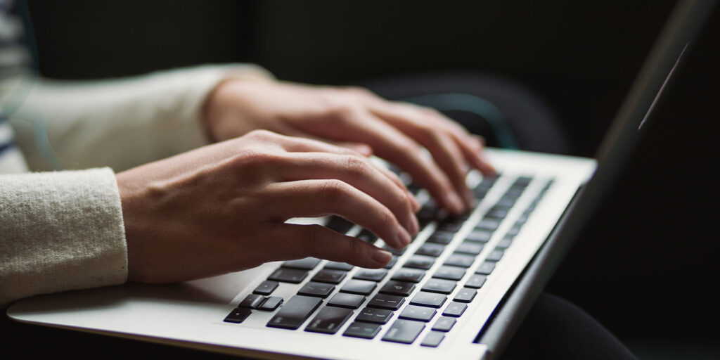 Person typing on a laptop.