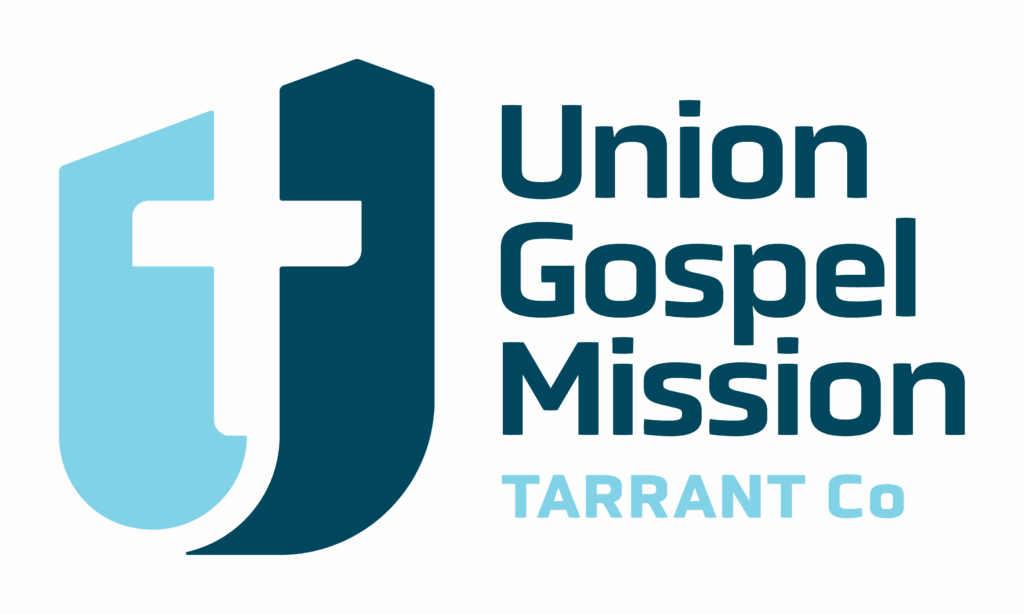 Union Gospel Mission Tarrant Co logo featuring a stylized cross and shield design next to the organization's name in bold text.